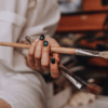 vecteezy_closeup-of-female-artist-hand-holding-paintbrush_3289326